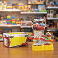 Toy race track set with 'Cars' branding in a toy store setting