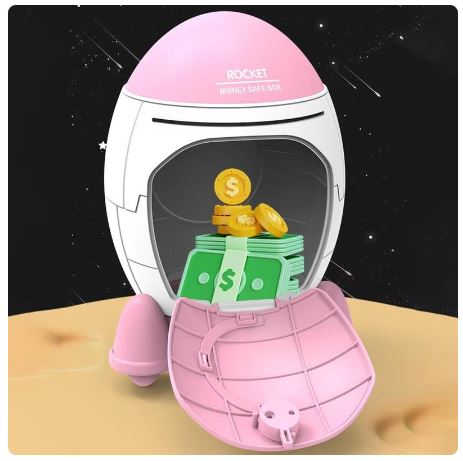 Pink and white space-themed money box with coins and money bills inside, on a wooden surface.