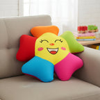 Colorful star-shaped pillow with a smiling face on a beige couch.