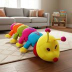 Colorful caterpillar-shaped plush toy on a wooden floor with a living room in the background.