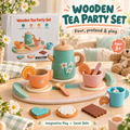 Wooden tea party set displayed on a round tray with a mint green teapot, orange and pink cups, blue mug, flowers, cookies, and the product box in a bright styled room scene.