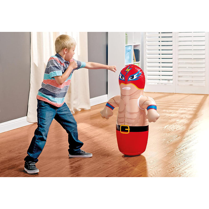 Child playing with an inflatable superhero toy on a wooden floor.