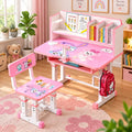 Pink children's desk and chair set with cartoon graphics, shown in a bright, styled room. The set includes a height-adjustable desk with a built-in shelf and book compartments, a matching chair, and a red backpack hanging from the desk leg.
