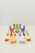 Colorful toy guns and accessories on a light gray background