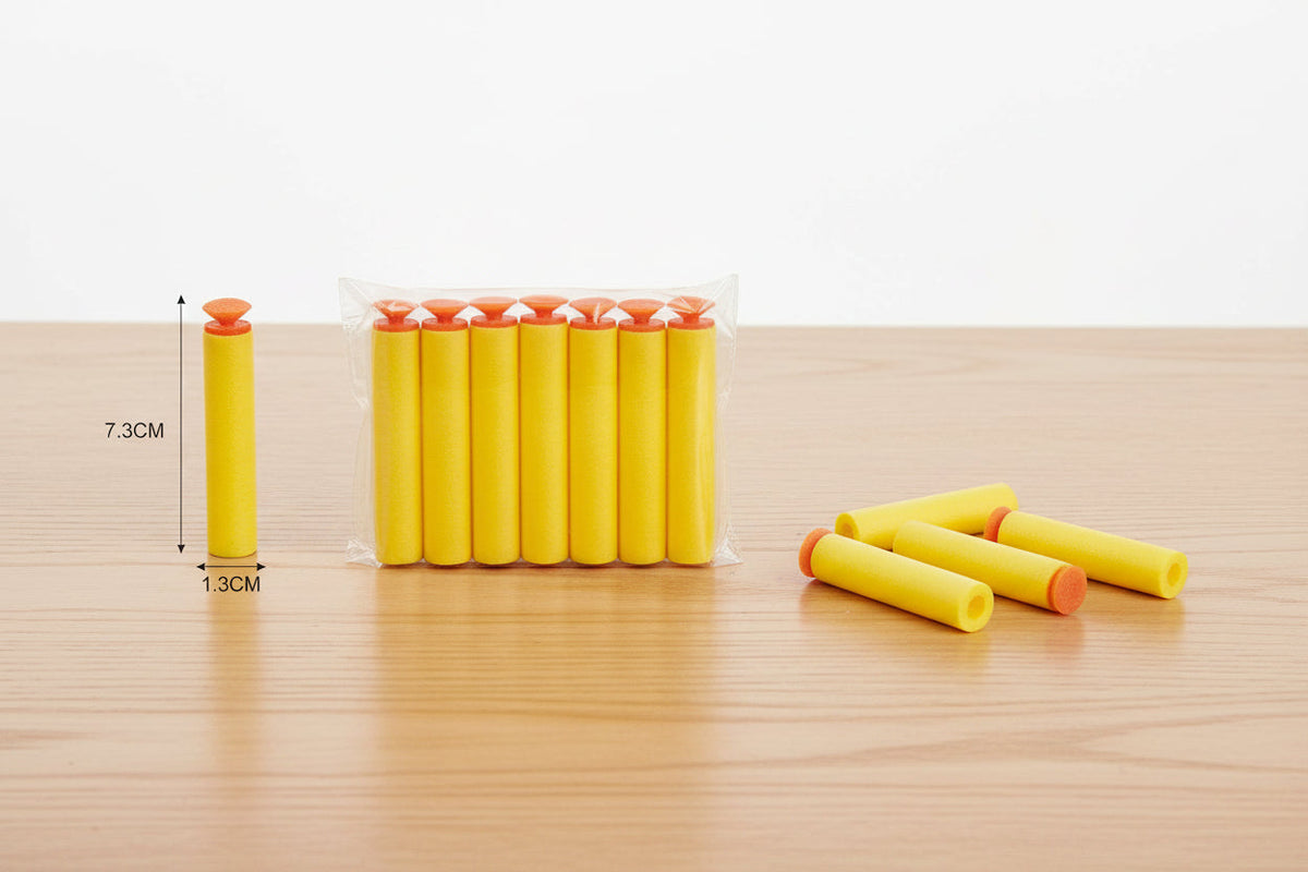 Yellow foam darts with measurement on a wooden surface