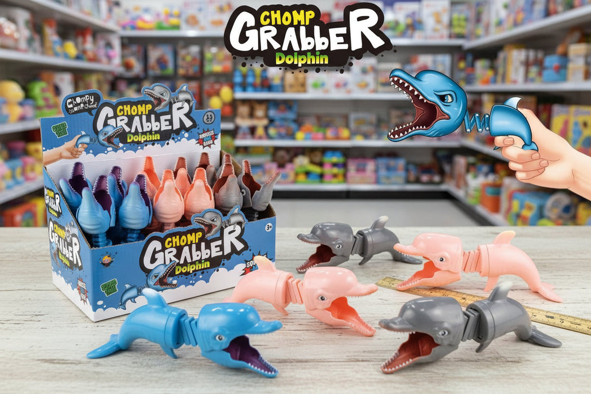 Chomp Grabber Dolphin toy with packaging and a hand holding one of the toys in a store setting.