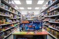 Toy aisle with a 'Space Wars' toy blaster box on a table
