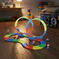 Colorful toy track set on a wooden floor with toys and furniture in the background