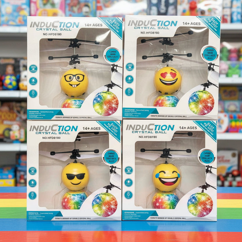 Four boxed toy products labeled INDUCTION CRYSTAL BALL NO. HTF0810 arranged in a 2x2 grid on a colorful toy store shelf.