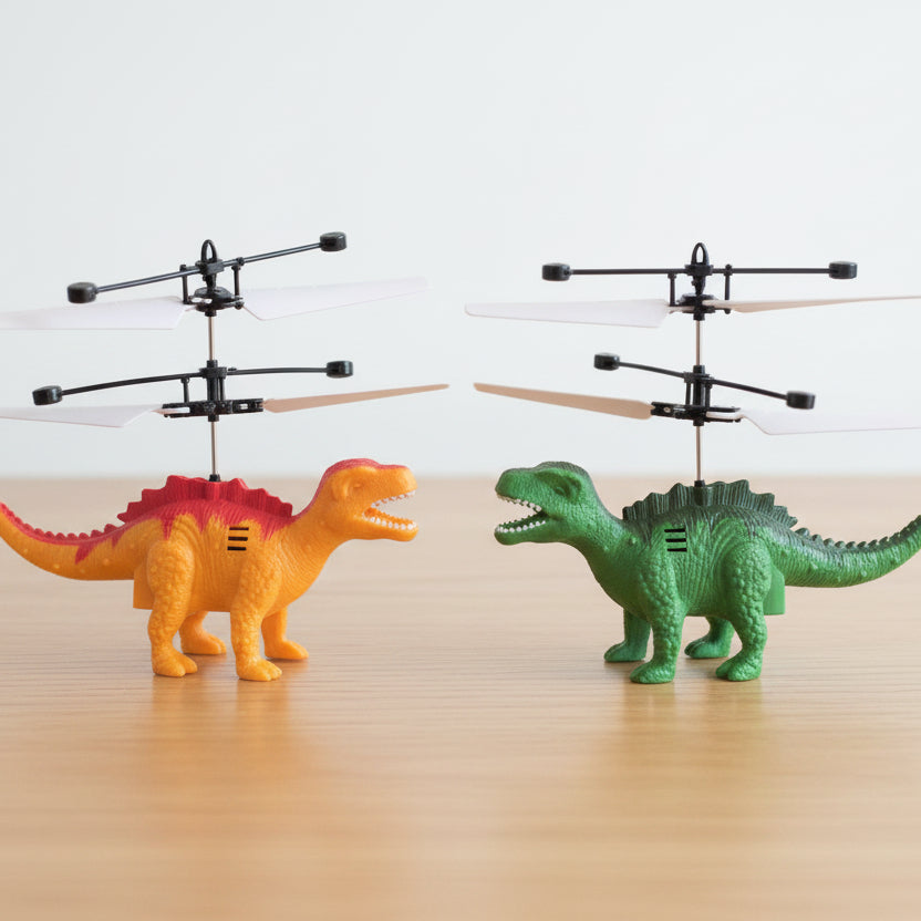 Two toy helicopters mounted on dinosaur figures, one orange with a pink back and one green with dark green spikes, displayed on a light wooden surface against a white background.