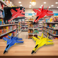 Three toy airplanes in red, blue, and yellow on a wooden surface with a blurred store background.