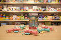 Toy robot on a table with a blurred toy store background