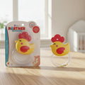 Yellow rubber duck with red head on a clear stand next to its packaging labeled 'Baby's Partner' on a wooden surface.