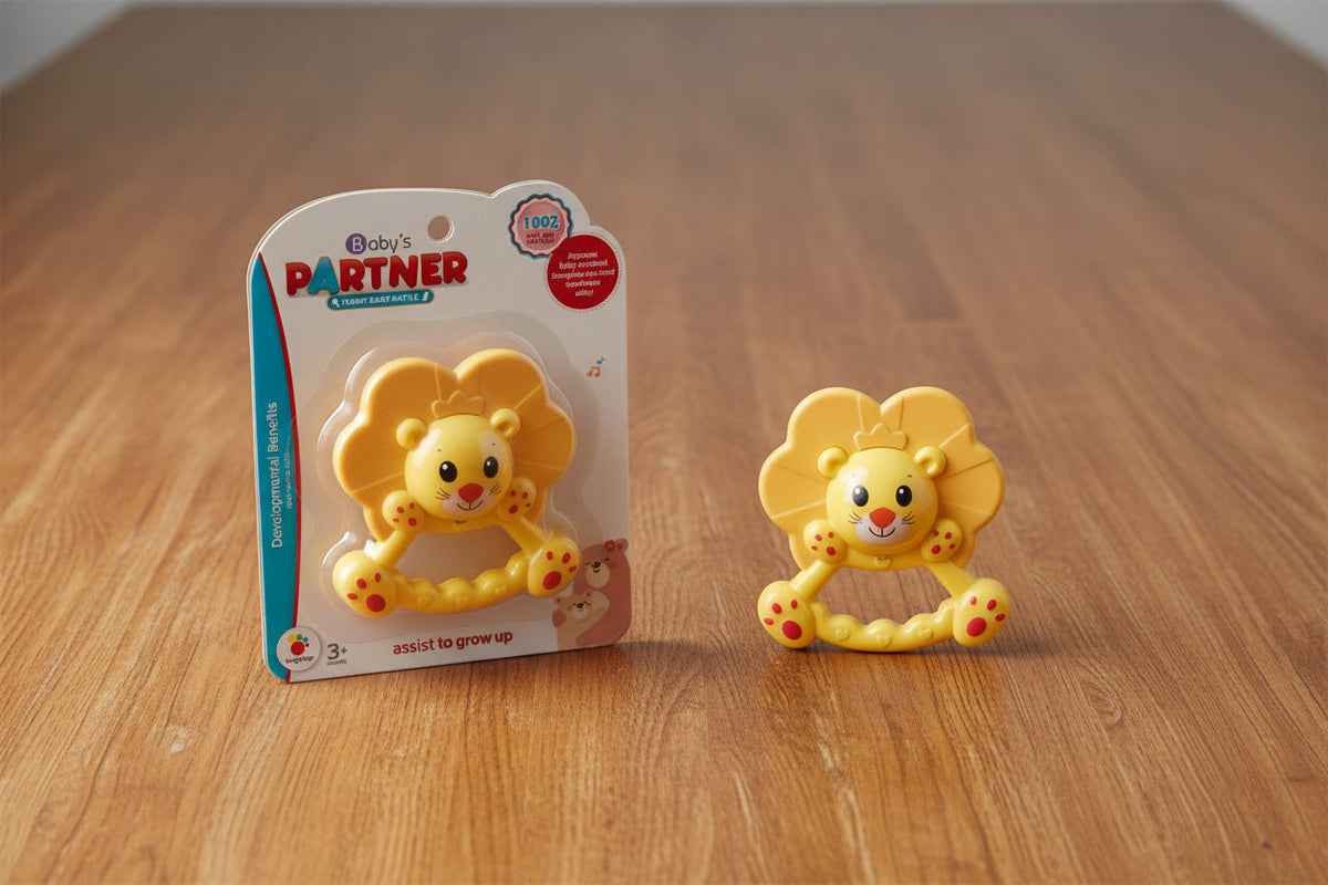 Yellow lion-shaped teether with packaging on a wooden surface