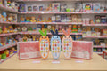 Three children's toy phones with colorful designs on a table in a toy store.