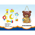 Set of colorful baby toys with a bear-shaped organizer on a blue background