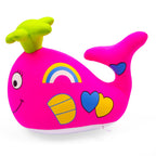 Colorful toy whale with a rainbow and heart designs on a white background
