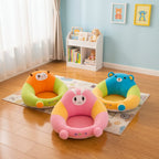Three colorful baby seats with cartoon designs on a wooden floor.