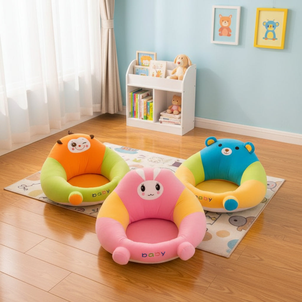 Three colorful baby seats with cartoon designs on a wooden floor.