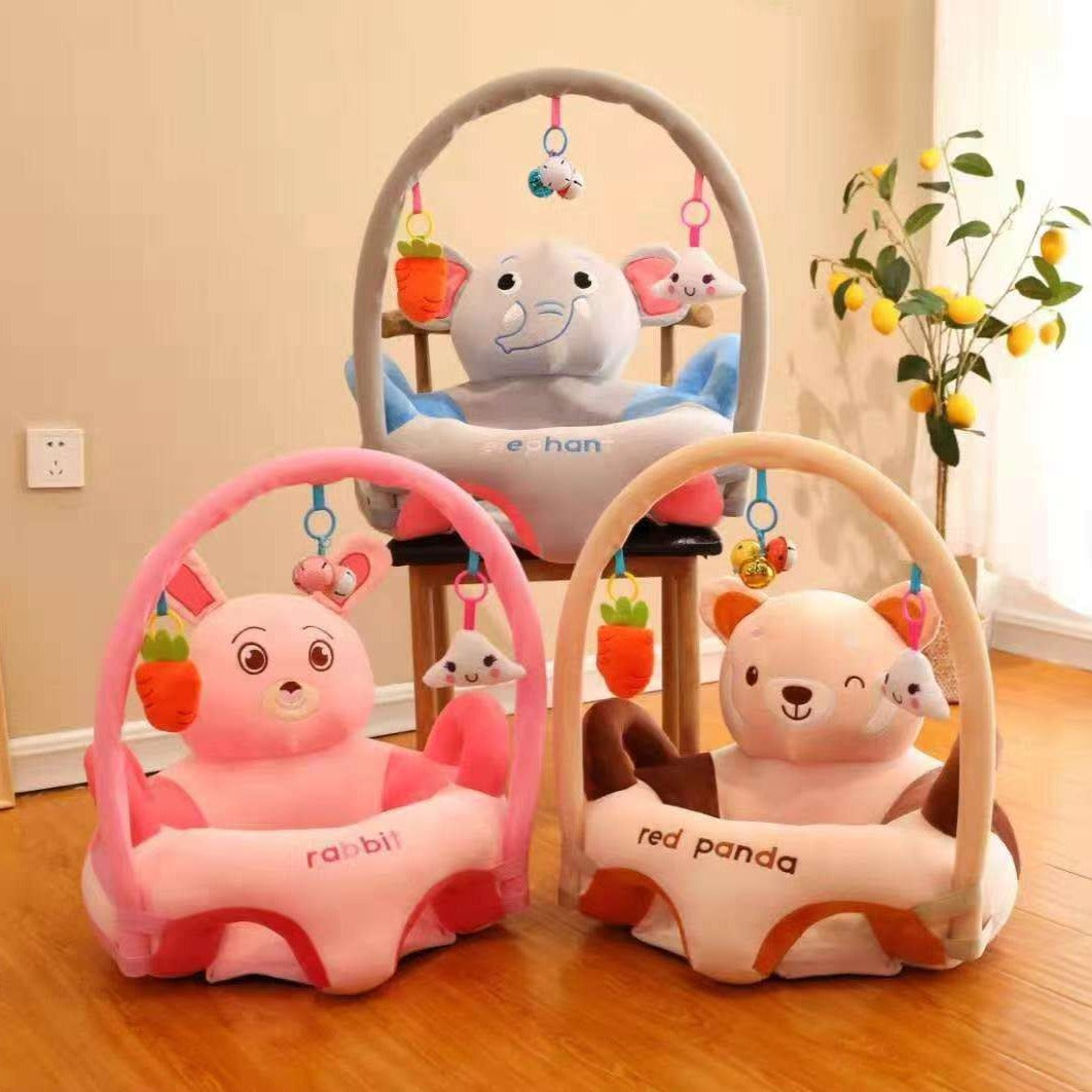 Children's activity centers with plush toys and hanging elements on a wooden floor.