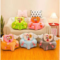 Colorful heart-shaped children's chairs on a wooden floor with a couch and lamp in the background.