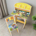 Children's desk and chair set with Winnie the Pooh design on a wooden floor.