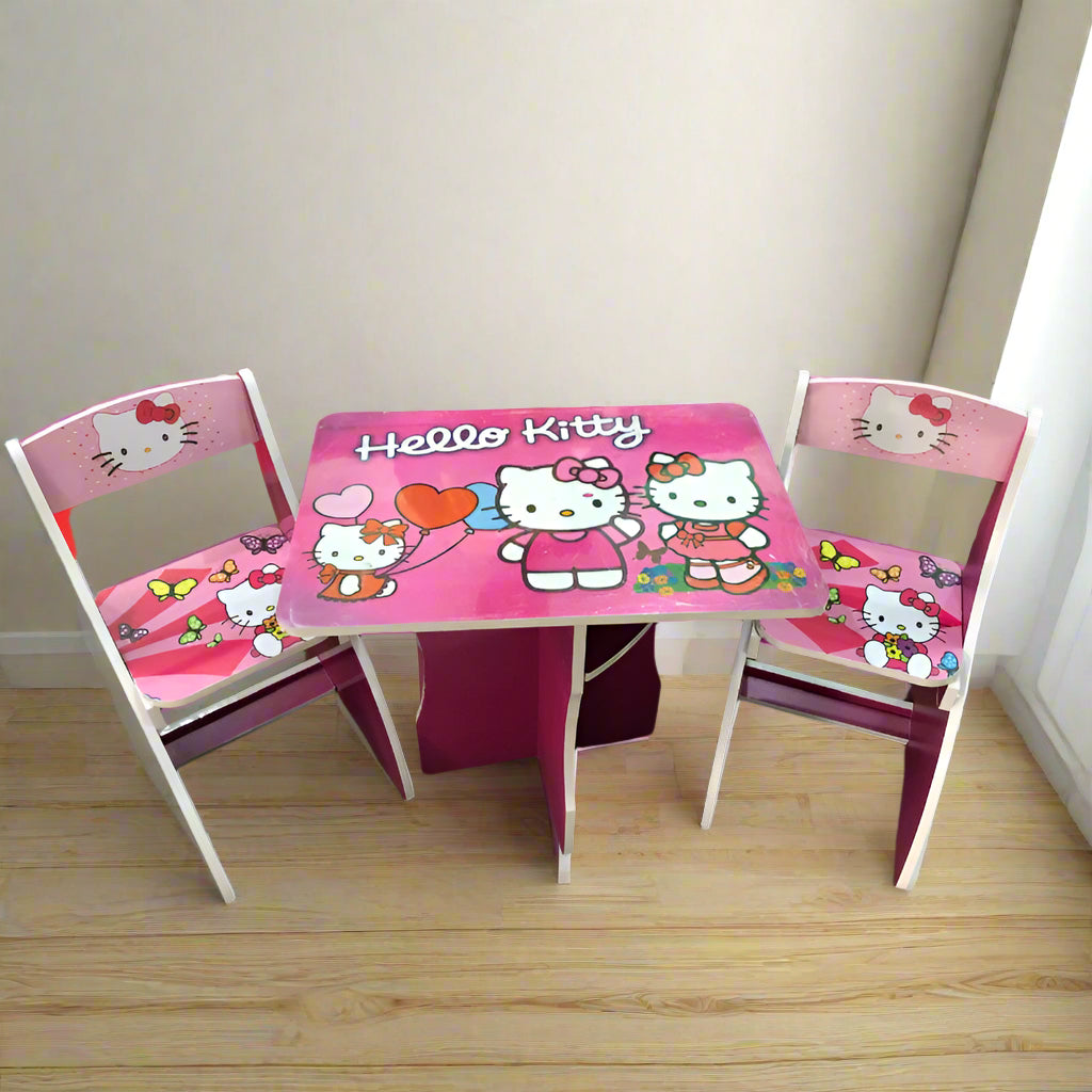 Hello Kitty table and chairs set on a wooden floor with a white wall background