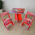 Children's table and chairs set with Disney Cars design on a wooden floor.