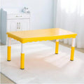 Yellow children's table in a room with white walls and a cabinet.