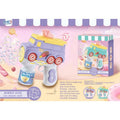 Electric bubble toy ice cream cone gun in light purple and white with yellow details, shown alongside its retail packaging box on a pastel pink background with candy graphics.