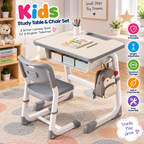 Kids study table and chair set in a bright room, featuring a white and gray adjustable desk with a chair, storage drawer, and side pocket holding a monkey backpack. The image includes feature icons on the right and a 'Kids Study Table & Chair Set' title at the top.
