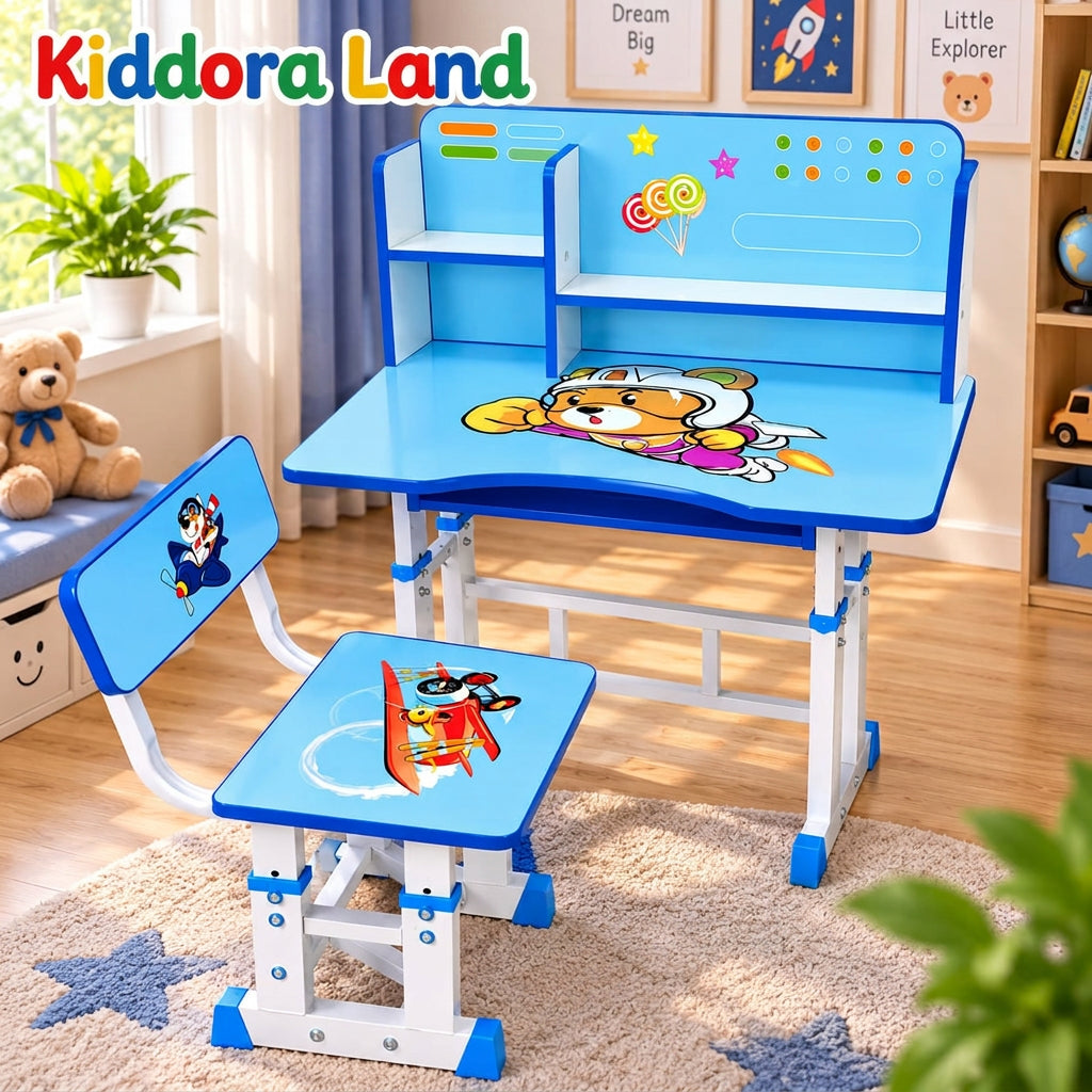 A children's desk and chair set by Kiddora land, decorated with cartoon graphics including a dog pilot and a red airplane. The set features a blue desk with white legs, a matching chair, and a backrest panel with colorful stickers and a progress bar, set in a child's bedroom.