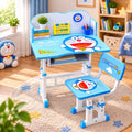 A children's height-adjustable desk and chair set in bright blue and white, decorated with Doraemon graphics, shown in a styled children's room setting.