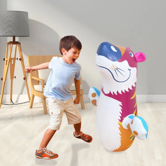 Child playing with a colorful inflatable toy in a room.