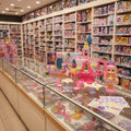 Toy store display with various toys and a pink toy castle.